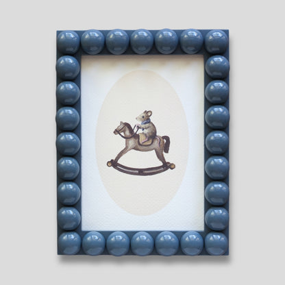 Mouse on rocking horse in Bobbin frame A6