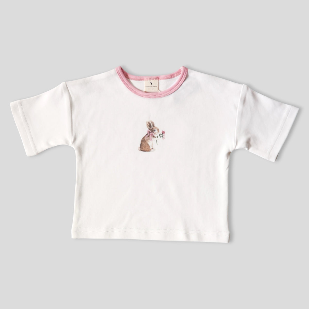 A white short-sleeve baby t-shirt with a pink ribbed crew neck and a small watercolor bunny graphic on the chest, displayed flat on a light gray background.